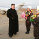 Image for article titled Kim Jong Un Visits Female Fighter Pilots, Picks Up Camera For Photo Op